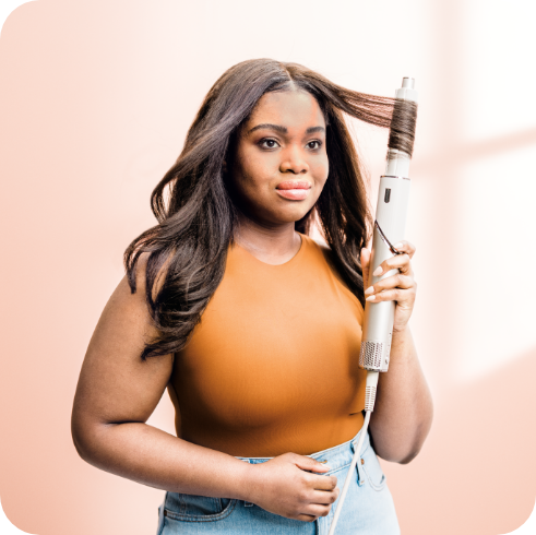 Woman styling hair with a Shark Beauty styler